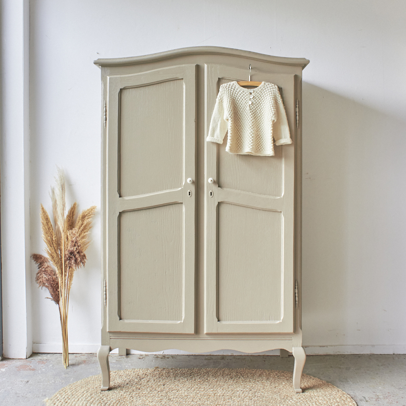 a wardrobe with a sweater on a swinger